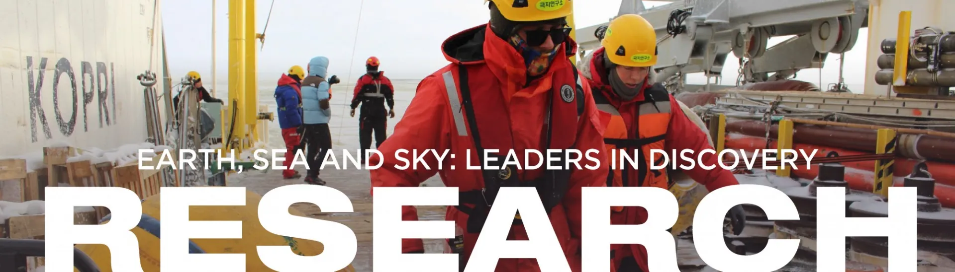 Crew on ship deck with text Earth, Sea and Sky: Leader in Discovery - Research