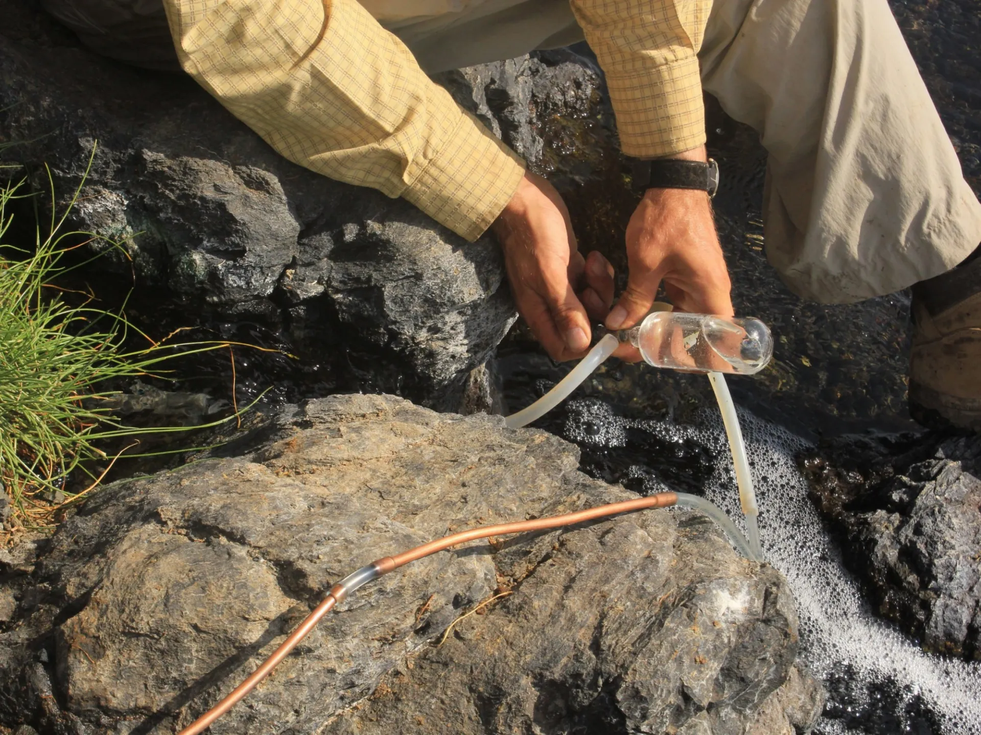 Sampling water from a stream. Credit: SESAR