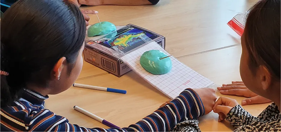 Students work with glacier material to test ice flow