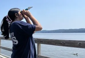 Next Gen Intern Sinduja measuring salinity of Hudson River water using a refractometer 