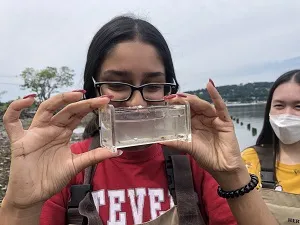 Shania Ninan is exploring juvenile fish in a nursery tank. 