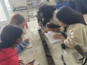 Interns look at a sediment core
