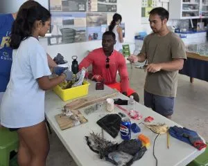 Next Gen interns Isabella, Ederson, Matt, and Austin sort marine debris collected while sampling 