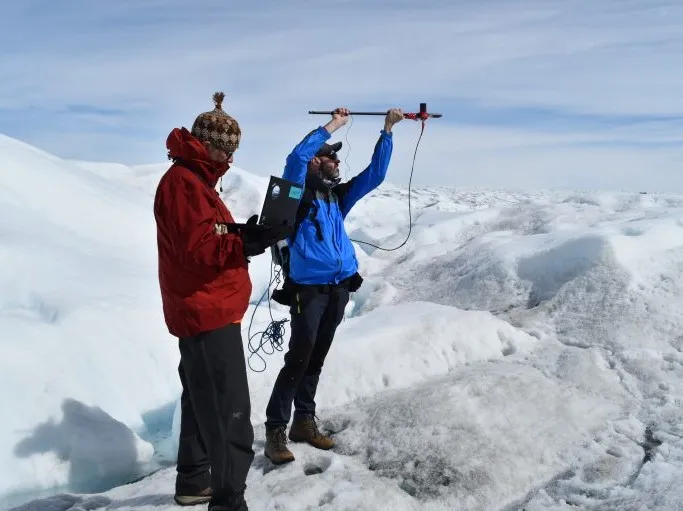 Lamont’s Marco Tedesco (measures the intensity and spectra of sunlight reflected off of ice in a spot near Kangerlussuaq in West Greenland. Credit: Kevin Krajick/Earth Institute