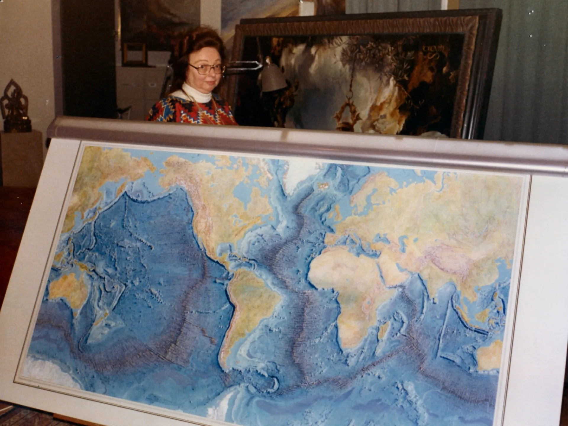 Marie Tharp with the iconic Heezen-Tharp World Ocean Floor map, a landmark in cartography. Credit: Lamont-Doherty Earth Observatory and the estate of Marie Tharp