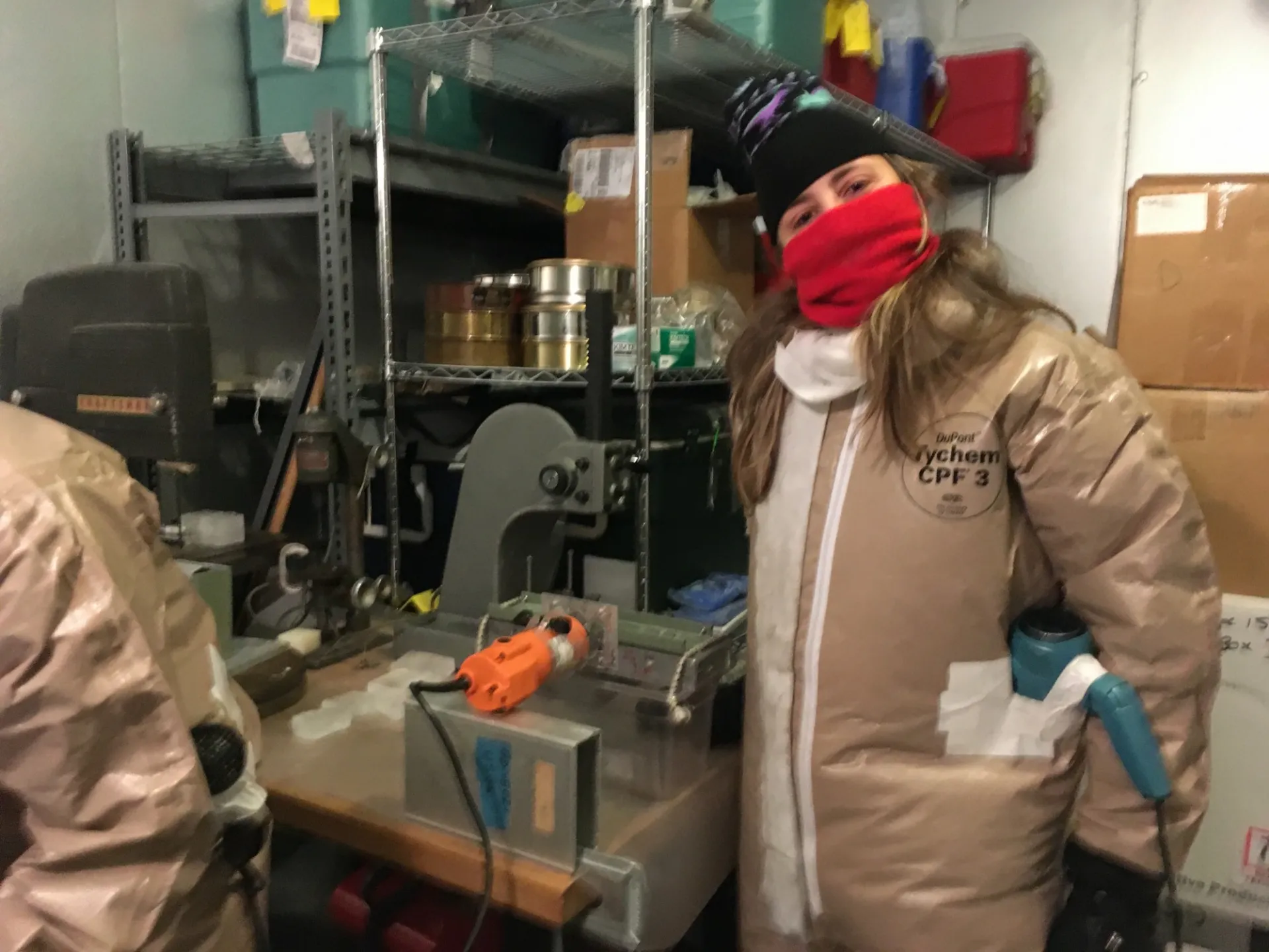 Nina Castro bundled up making seed ice in the freezer (2020).