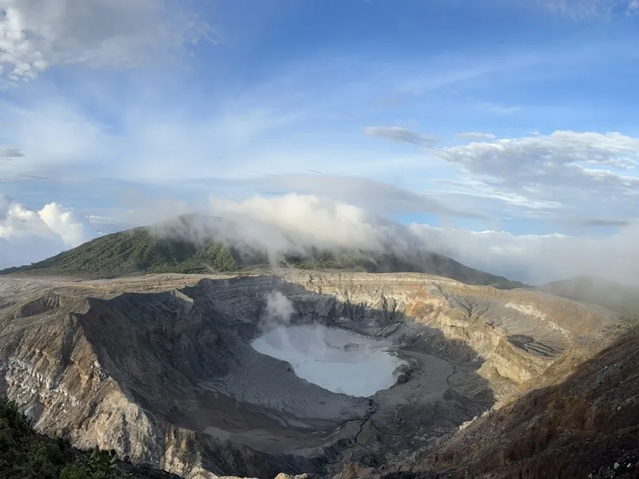 The mile-wide crater of Costa Rica’s Poás Volcano hosts a steaming lake that occasionally explodes. Debris from past eruptions covers an area of 150 square miles around it. Credit: Kevin Krajick