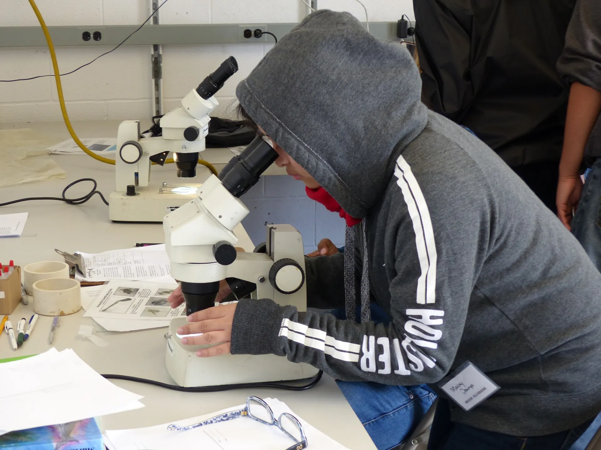 Student looks through a microscope. Credit: Margie Turrin