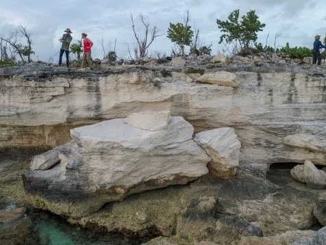 Surveying coastal rocks on the archipelago’s Crooked Island formed when sea levels were higher. Credit: Blake Dyer