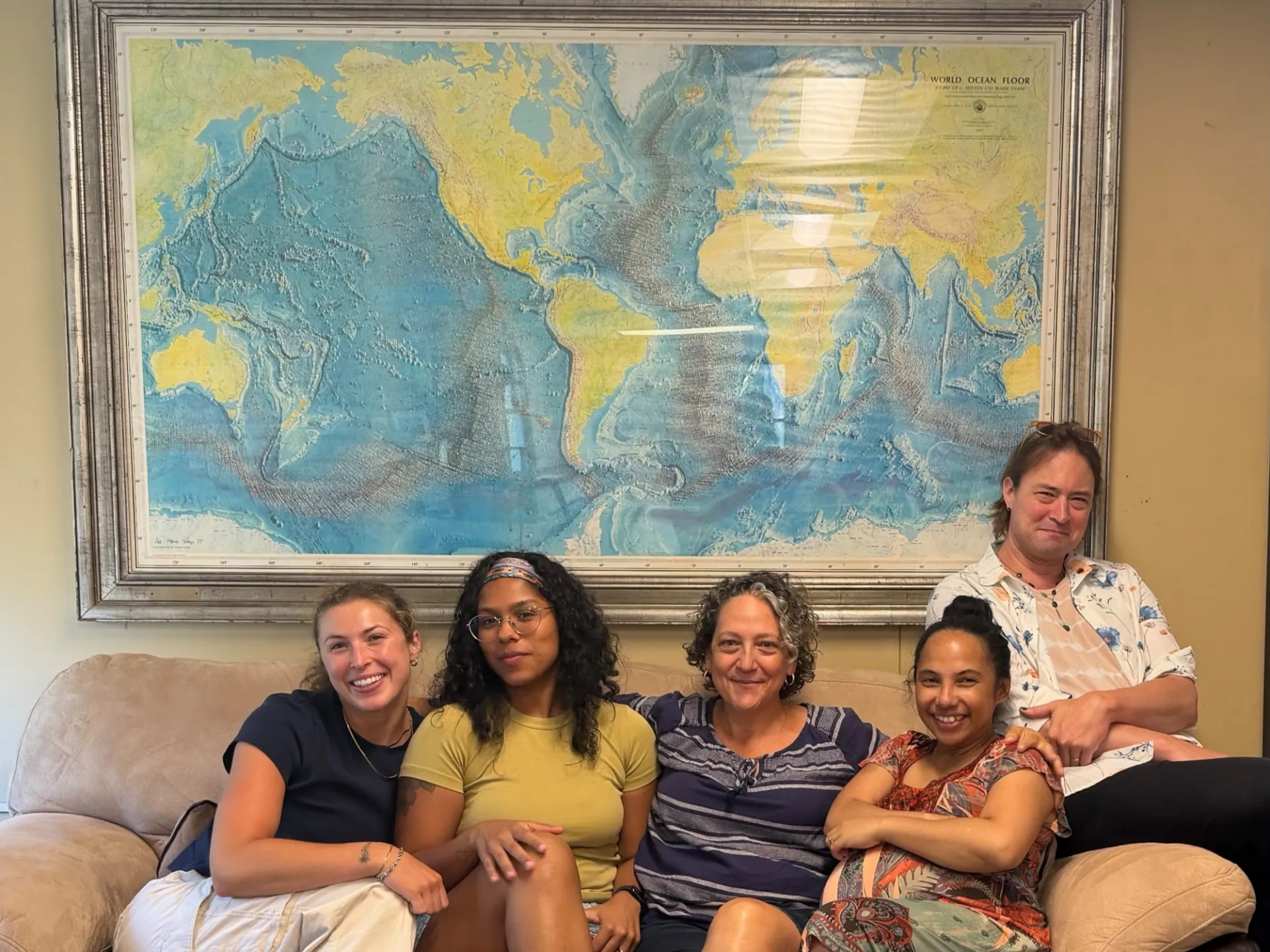 Vicki Ferrini and her team in front of the iconic 1977 world ocean floor map by Tharp and Heezen. From left to right: Maddie Young, Sheila Caceres, Ferrini, Tinah Martin, John Morton. Credit: Ashley Riz Advincula