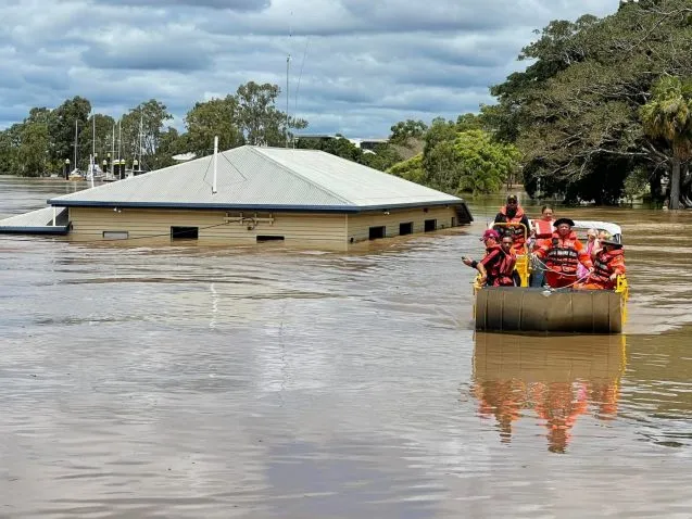 a boat passes a flooded home