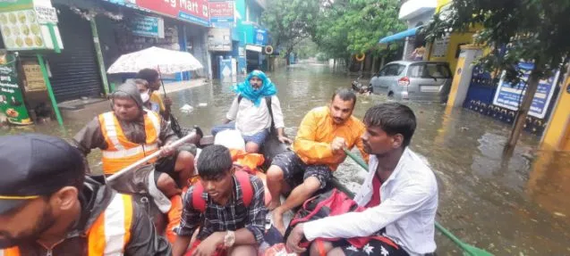 people in boat on city street