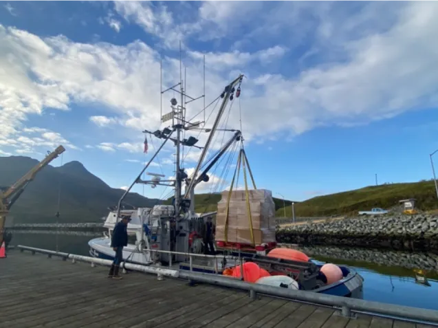 crane putting food and gear onto a boat