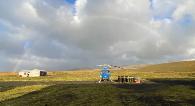 helicopter outside a cabin
