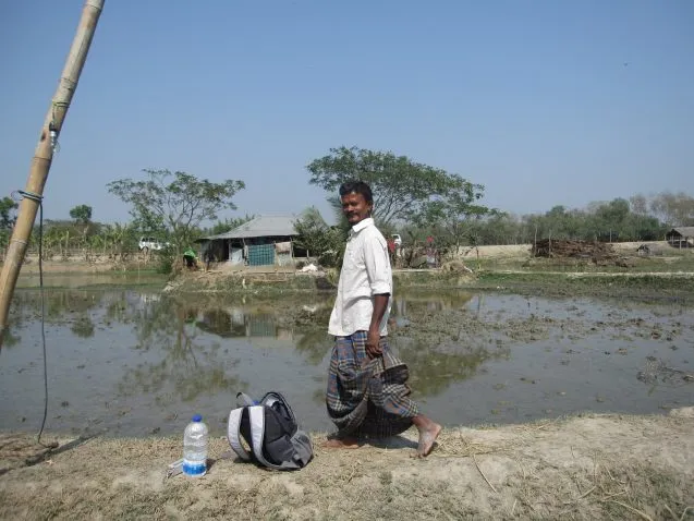 man walking across a dike