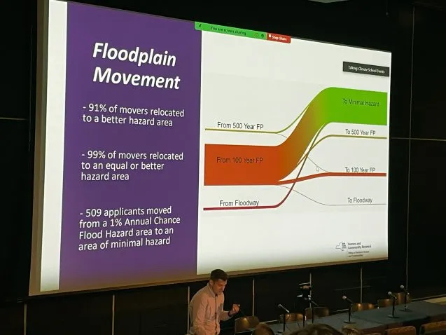 man stands in front of power point chart