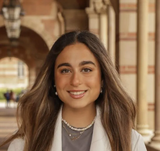 Woman smiles in white jacket