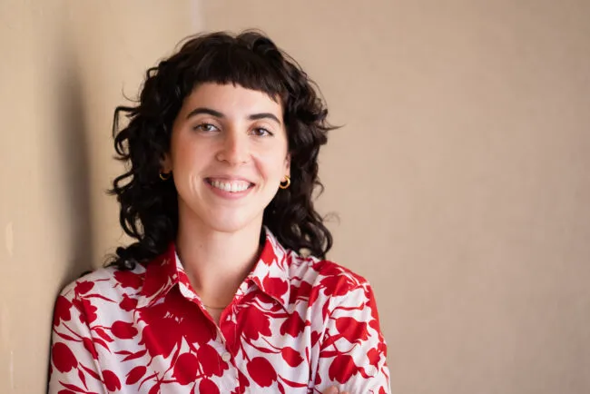 Headshot of woman in red and white top