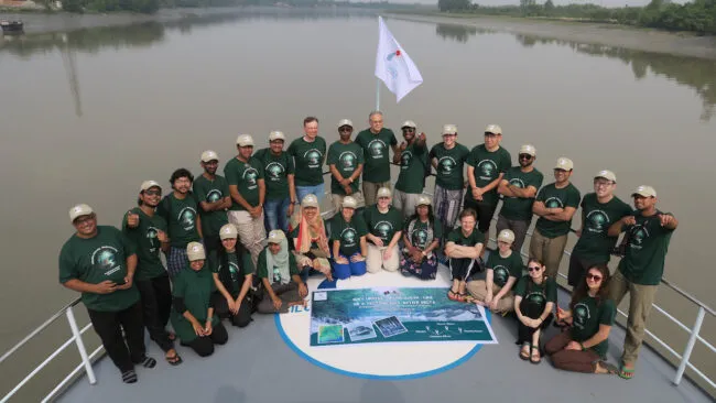 Group in matching shirts aboard a ship