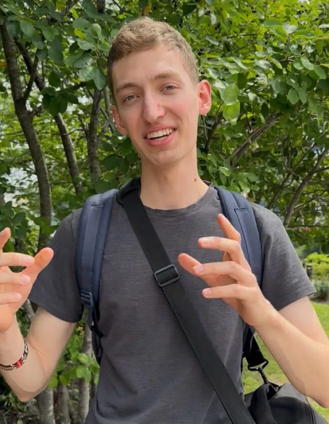 Student in front a of a tree