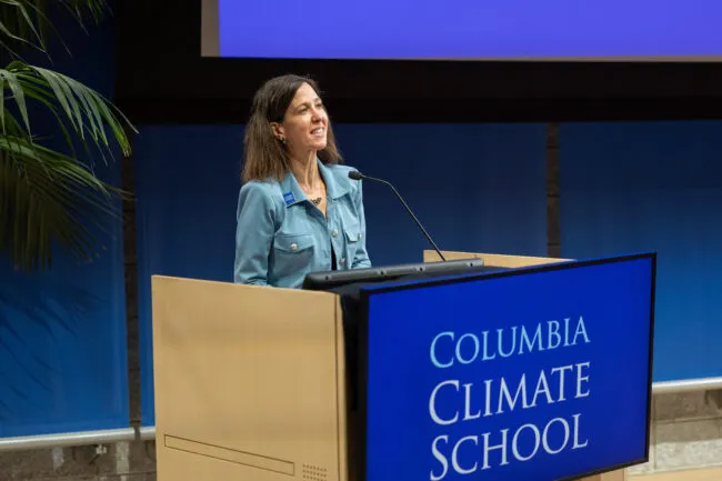 Climate School Dean Alexis Abramson introduces the Climate School Showcase at a podium