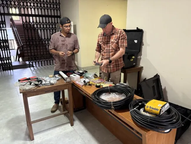 Two men working to organize equipment