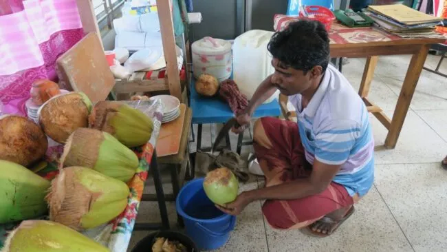 Man serves green coconut 