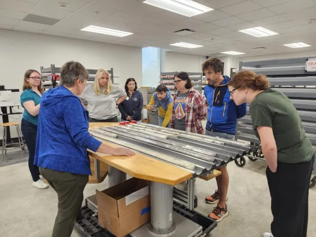 Teachers learning from a scientist in the lab