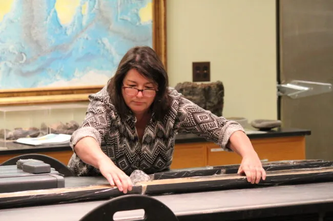 Paleoclimatologist and marine geologist Maureen Raymo with an ocean sediment core in the Lamont Core Repository.
