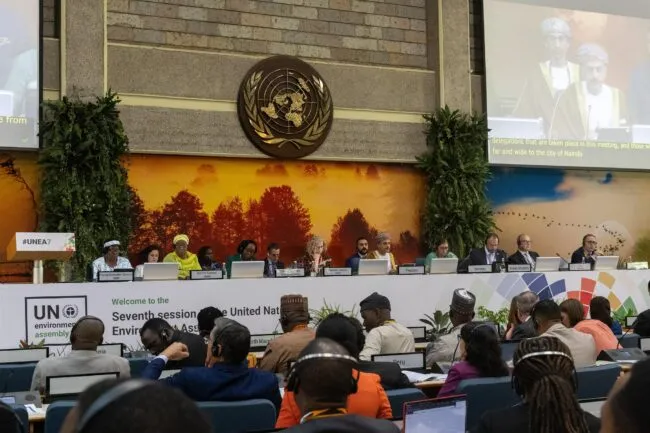 United Nations Environment Assembly meeting with delegates seated at the dais and audience in the hall