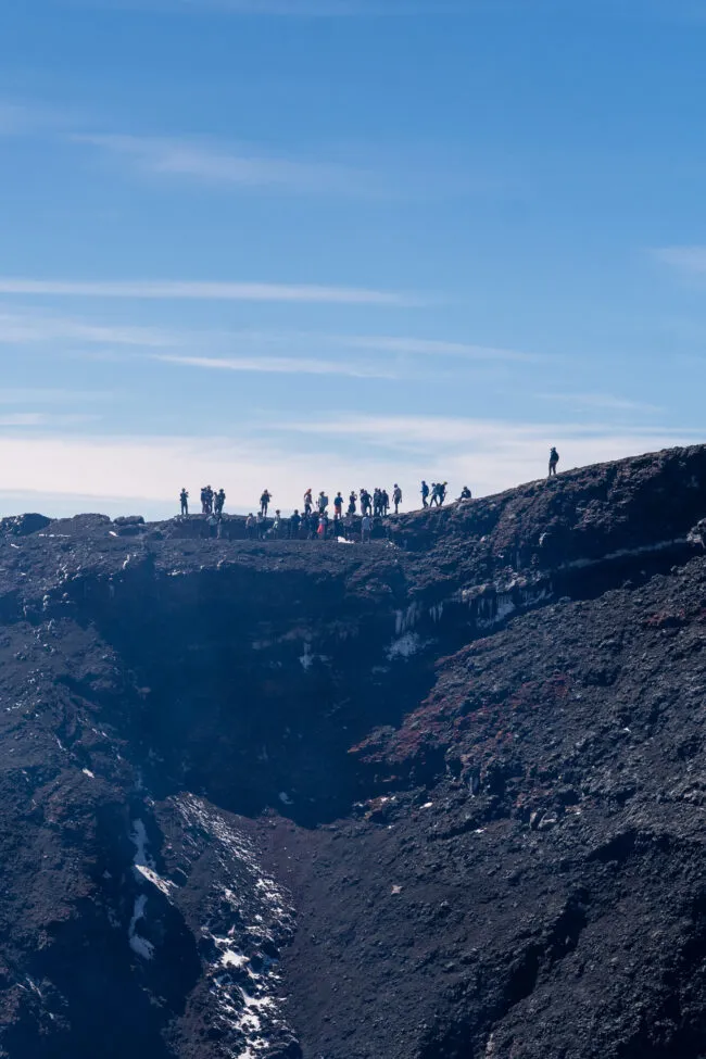 silhouette of hikers on top of villarrica.