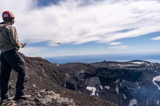 Each day, the helicopter would make nearly a dozen trips from the base camp to the rim, hauling everything from cement bags to heavy equipment, tools, solar panels, and the 32 lead-acid batteries that would provide continuous power to the instruments