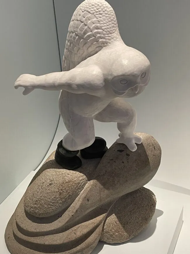 A sculpture showing a a man transforming into a bird