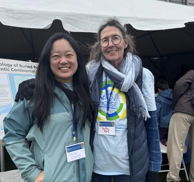 Dorothy Peteet and Clara Chang smile in front of a poster