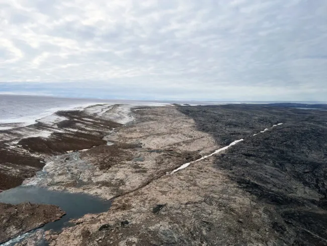 The end of a glaciation. Prominent trimline marks the 1960 extent of the Barnes Ice Cap. The dark colored landscape hosts mature vegetation and lichen cover, whereas the light-colored rock is vegetation free. Ice margin retreat from this trimline has