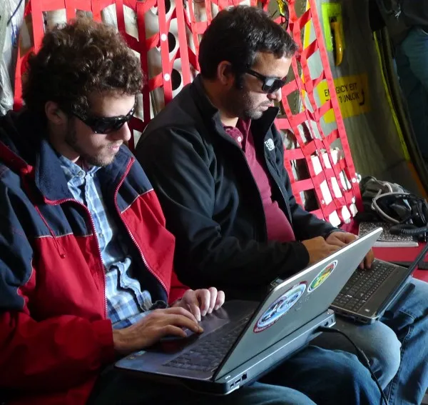 Mike Wolovick and Tej Dhakal troubleshoot radar data wearing appropriate eye protection gear! (Photo M. Turrin)