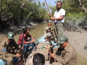 Sailing up a small channel to the Shakher Temple with our armed guards and a local fisherman guide (at prow).