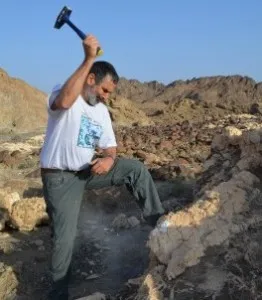 Person hammering rock