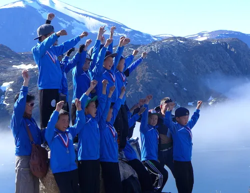 While waiting at the airport for our helicopter, a small plane arrives from Upernavik filled with a local sports team decorated with medals hanging from ribbons around their necks. Tossing coins in celebration is part of the reception. (Photo M. Turrin)