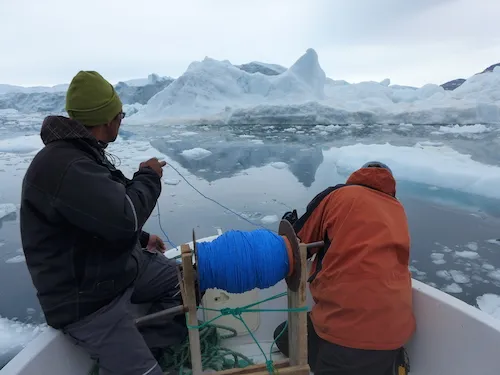 Magnus Petersen and Dave Porter prepare to lower the CTD into the fjord. (Photo M. Turrin)