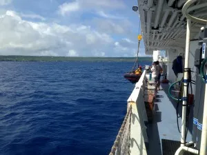 Preparing the Zodiac to transport the injured crew member to land.