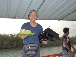Doug balancing his camera and his breakfast of puri and dal on the Elmar, our boat for the day