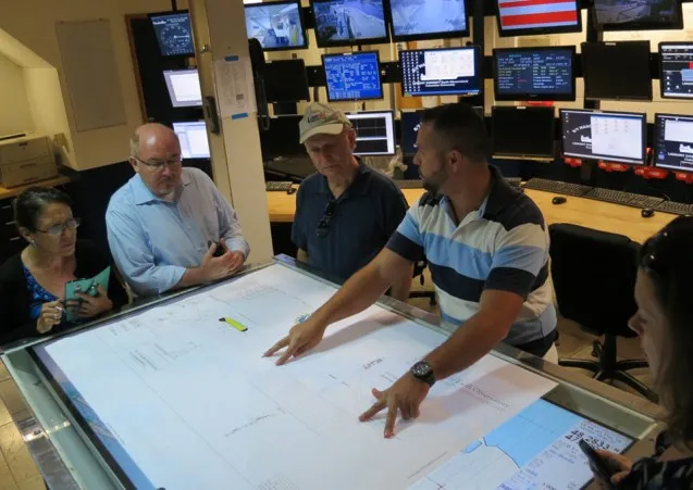 Bobby Kaprowski shows visitors a chart of the seismic streamer system used for a recent survey.