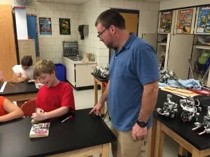 Geoscientist Tim Kenna works with his son's class to decorate boats for the Float Your Boat project. Jack Kenna works to get his boat 'Arctic ready'. 