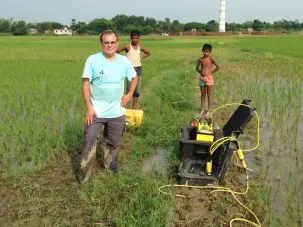 Standing ankle deep in mud by the resistivity meter.  The smokestack of the brick factory can be seen in the distance.