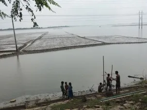 View across the river valley from the road.  The broad valley is mostly still underwater over a month after the end of the monsoon.  The road I am standing on is elevated so it does not flood, while the drillers work from the base of the road.
