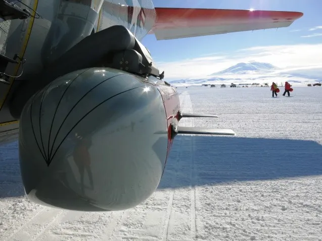 Moving across the ice with IcePod in the front and active Volcano Mt. Erebus in the distance.