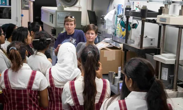Before the <i>Joides Resolution</i> leaves port, Lisa Crowder (left) and Rebecca Robinson (right) take students from a girls' school in Mauritius on a tour. Photo: Tim Fulton/IODP