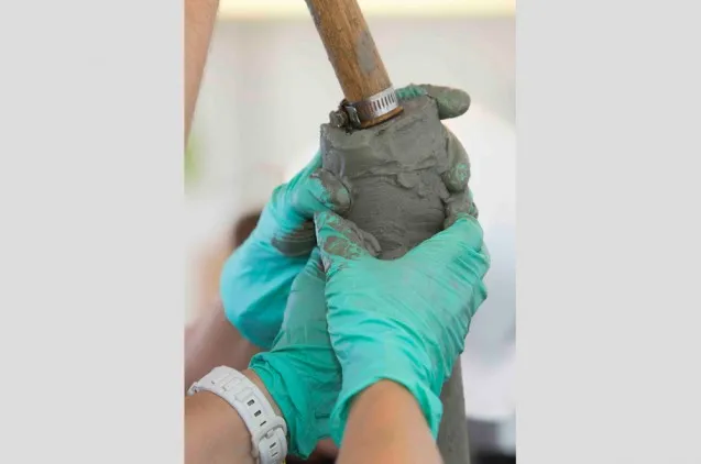 Scientists work the core catcher, which holds each segment of core in as it lifted from the sea floor. (Tim Fulton)