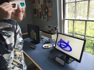 DEES graduate student Laura Haynes dons 3D goggles to view Jonny Kingslake's video "The Nye Attractor"